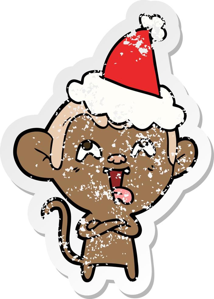 crazy distressed sticker cartoon of a monkey wearing santa hat vector