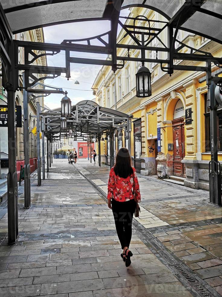 A person walking down a sidewalk photo