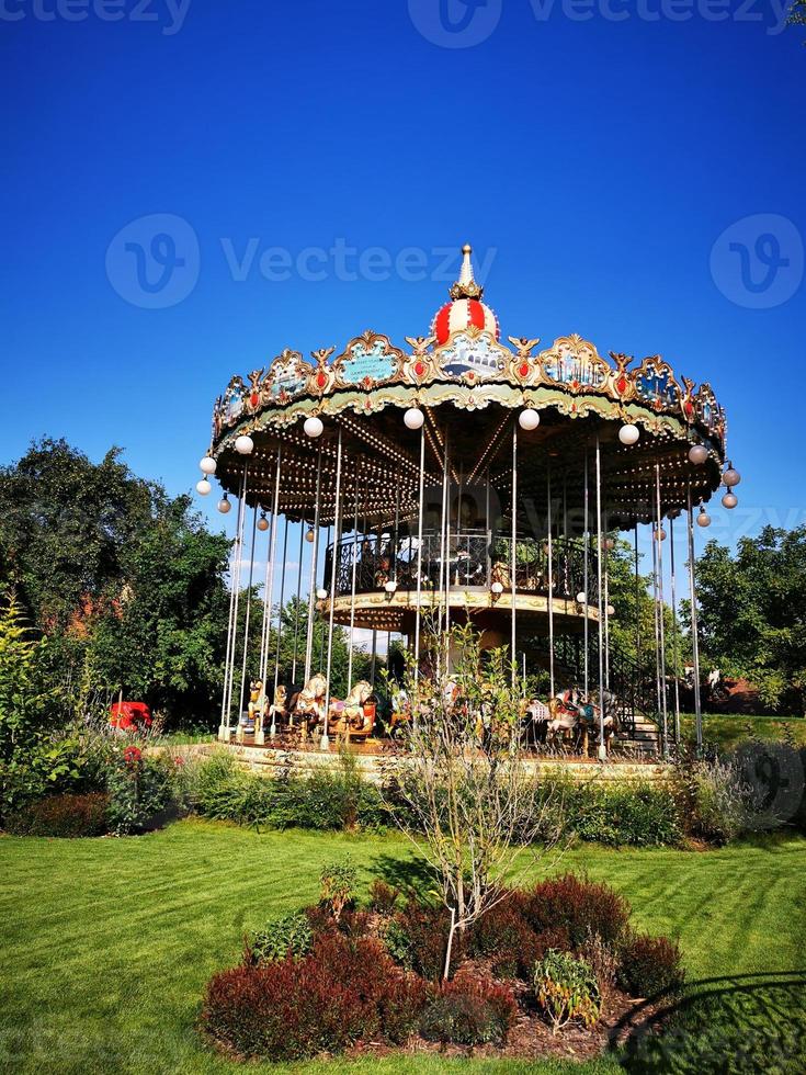 A carousel in front of a building photo