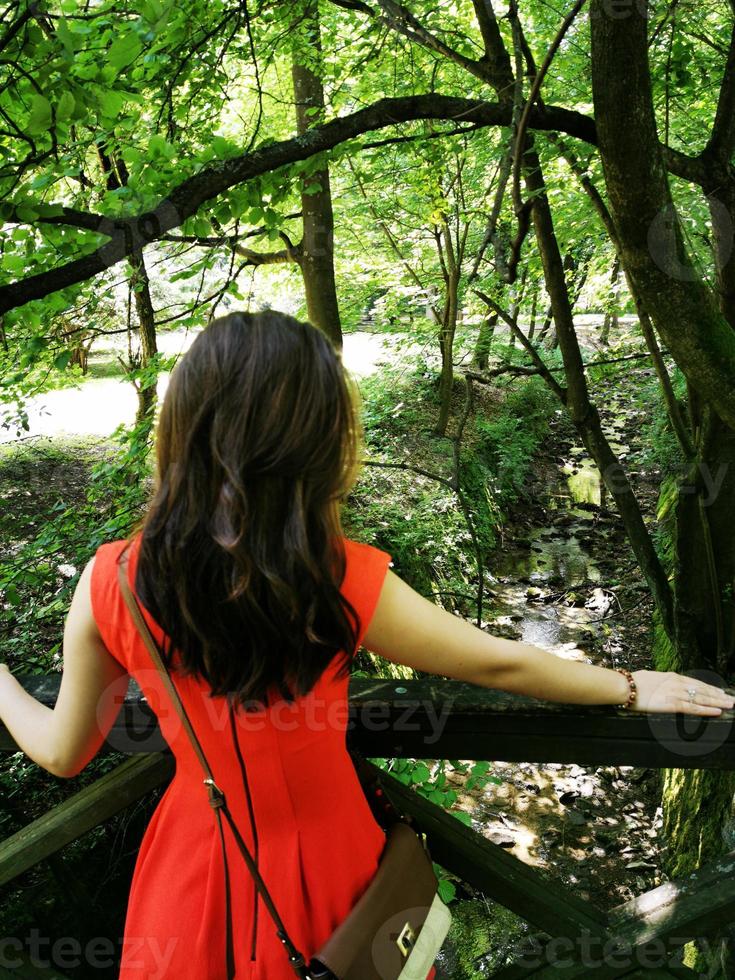 A woman standing next to a tree photo