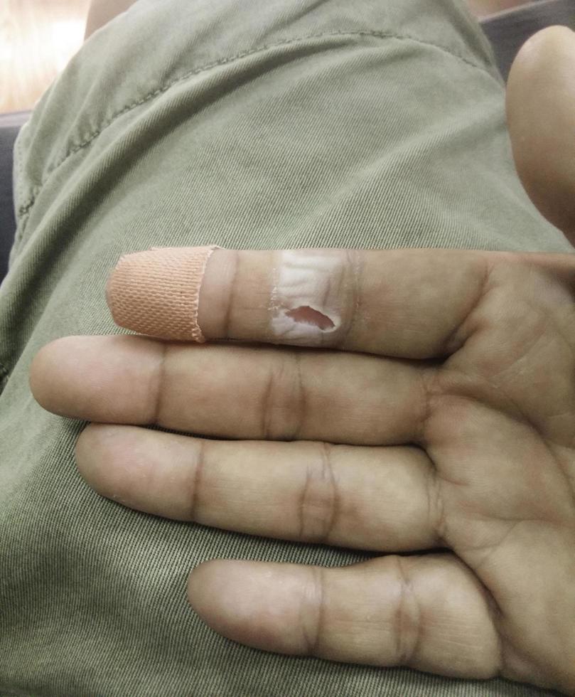 plaster on lesion finger for first aid concept photo