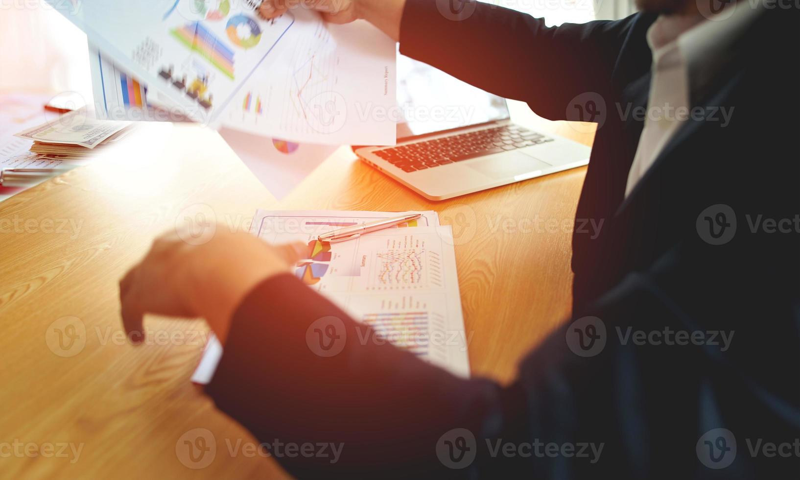 The business owner is busy planning his errands and has a laptop on his desk. photo