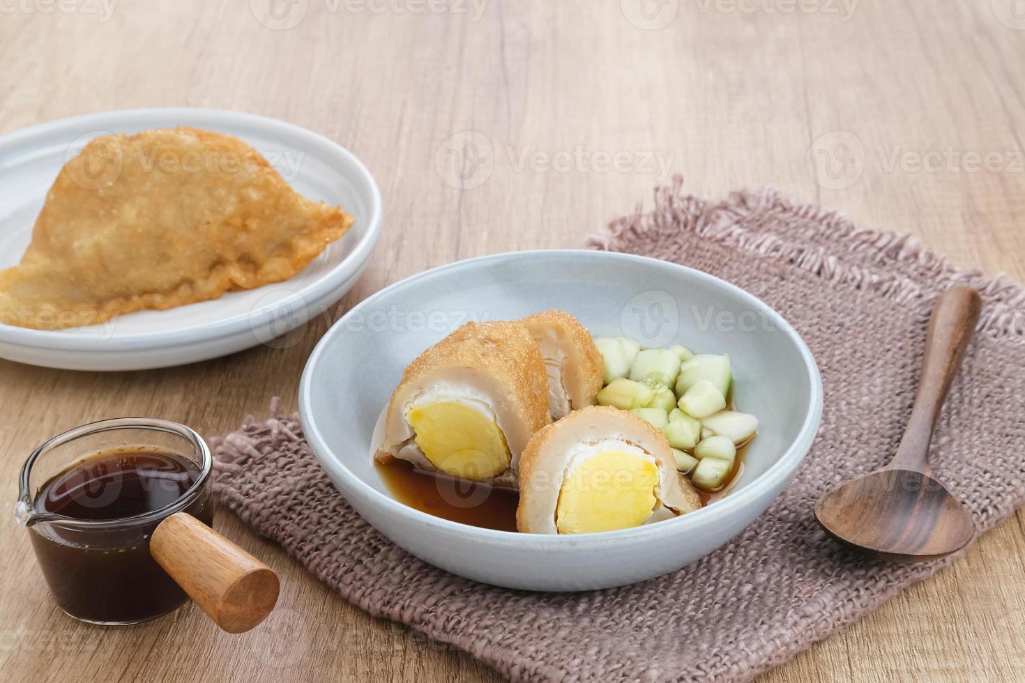 Pempek, Empek-Empek, traditional food from South Sumatra, Indonesia. This fish-based food is very popular. Served with cuko sauce and cucumber slices. photo