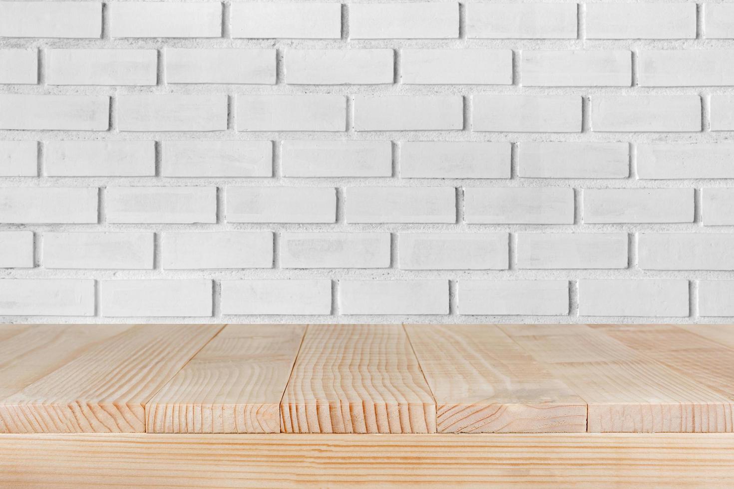 Wood table top on white brick background- can be used for montage or display your products photo