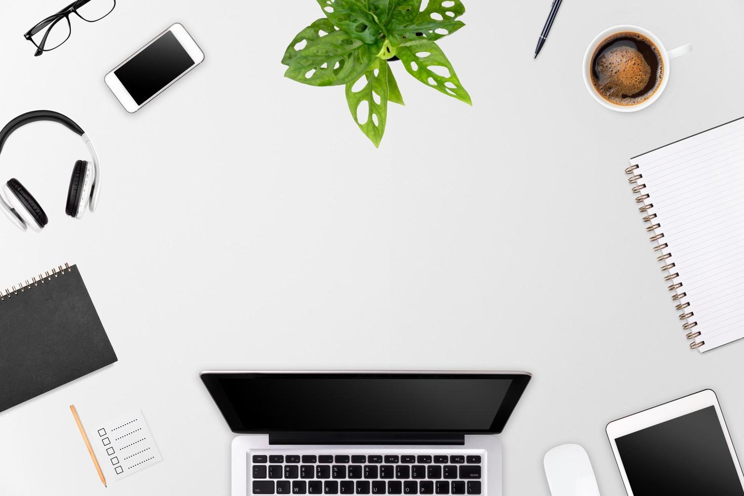 Modern workspace with laptop tablet, smartphone and coffee cup copy space on color background. Top view. Flat lay style. photo