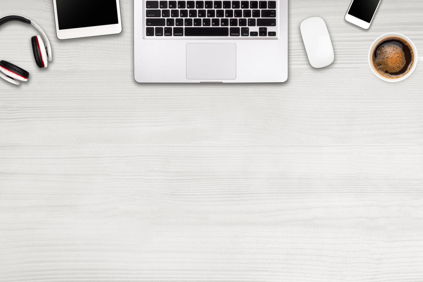 Modern workspace with laptop tablet, smartphone and coffee cup copy space on wood background. Top view. Flat lay style. photo