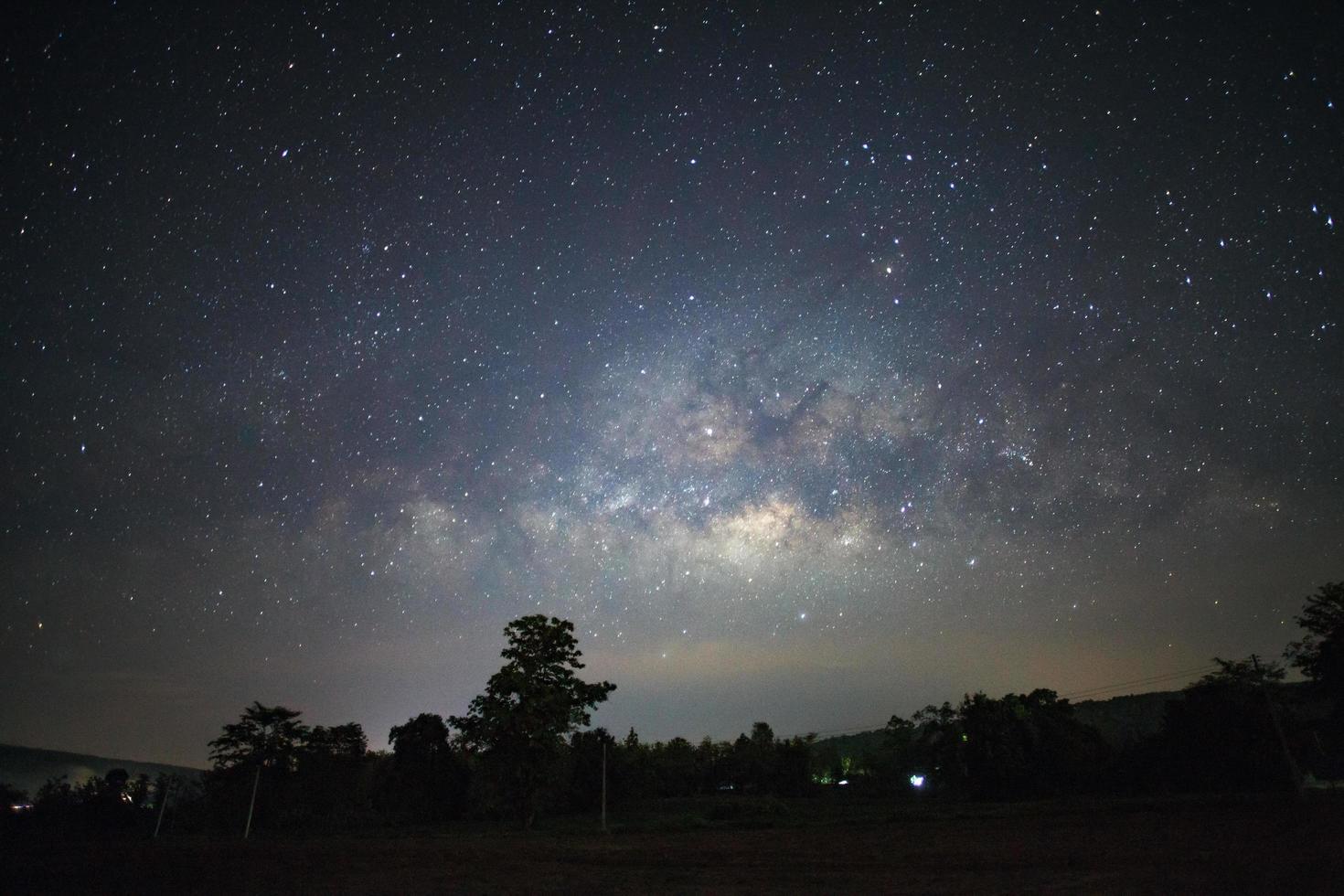 Milky Way and silhouette of tree at Phitsanulok Thailand, Long exposure photograph.with grain photo