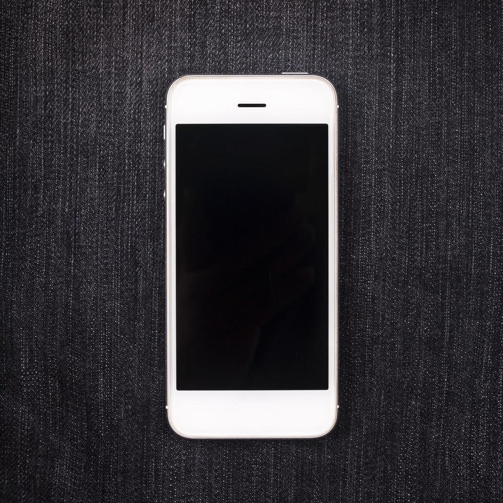 white mobile phone on pocket with black screen photo