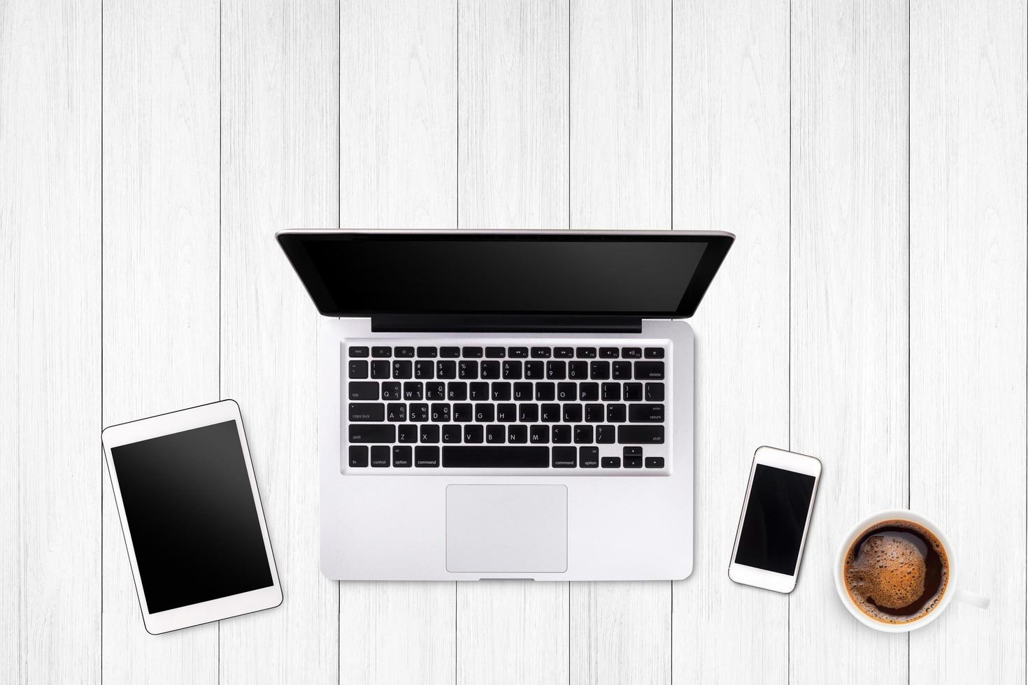 Top view laptop computer or notebook,mobile phone and cup of coffee on wooden table. Business template mock up for adding your text. photo