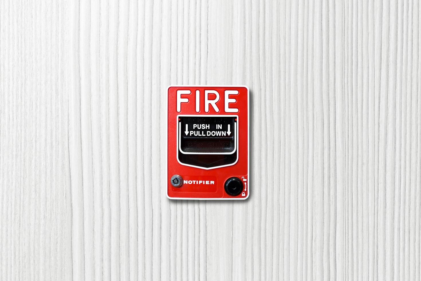 Fire alarm switch on white wood background photo