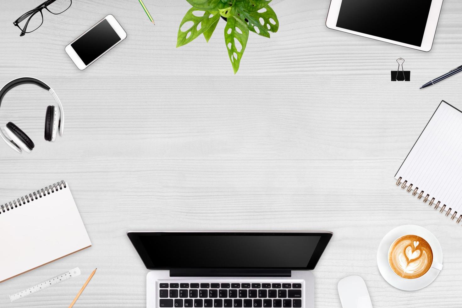 Modern workspace with laptop tablet, smartphone and coffee cup copy space on color background. Top view. Flat lay style. photo