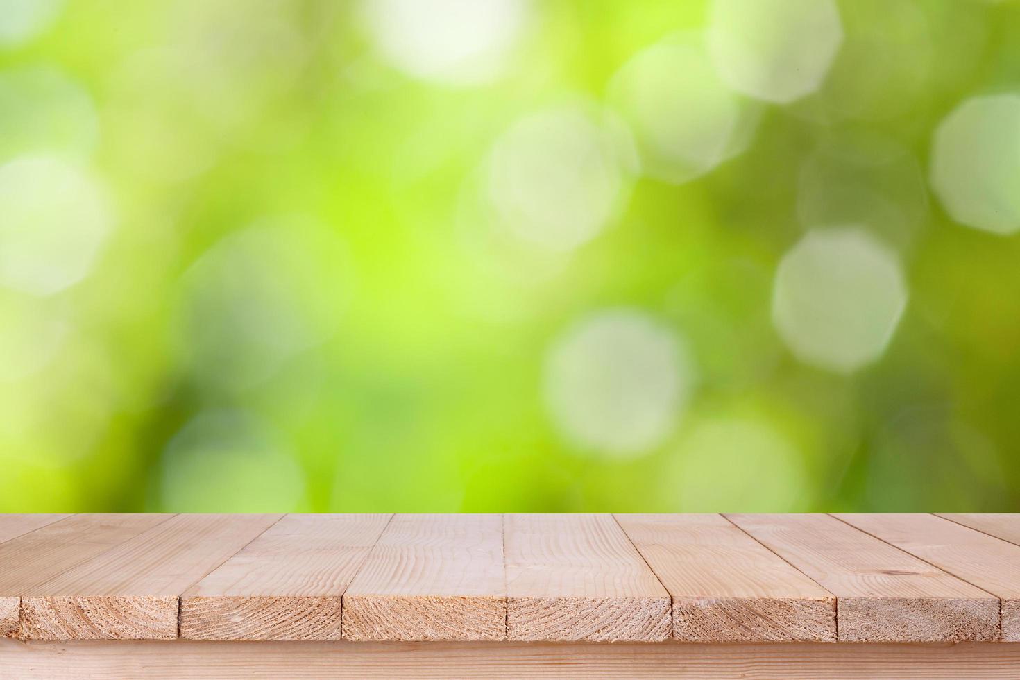 brown wood table top on bokeh abstract green background - can be used for montage or display your products photo