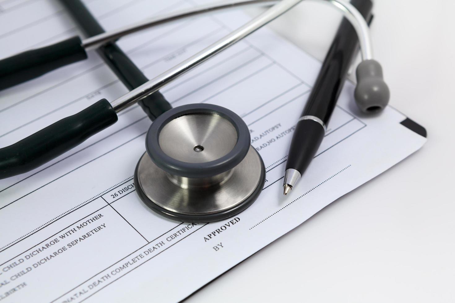 Close-up pen and stethoscope on blank Patient information photo