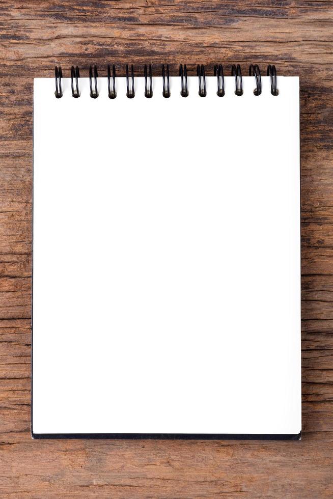 Blank empty notepad on wood background photo