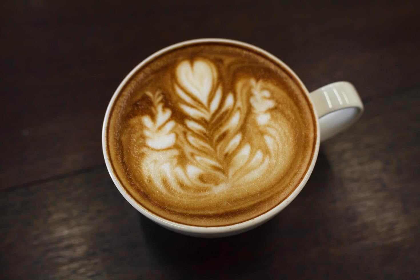Close-up latte art coffee on wood photo