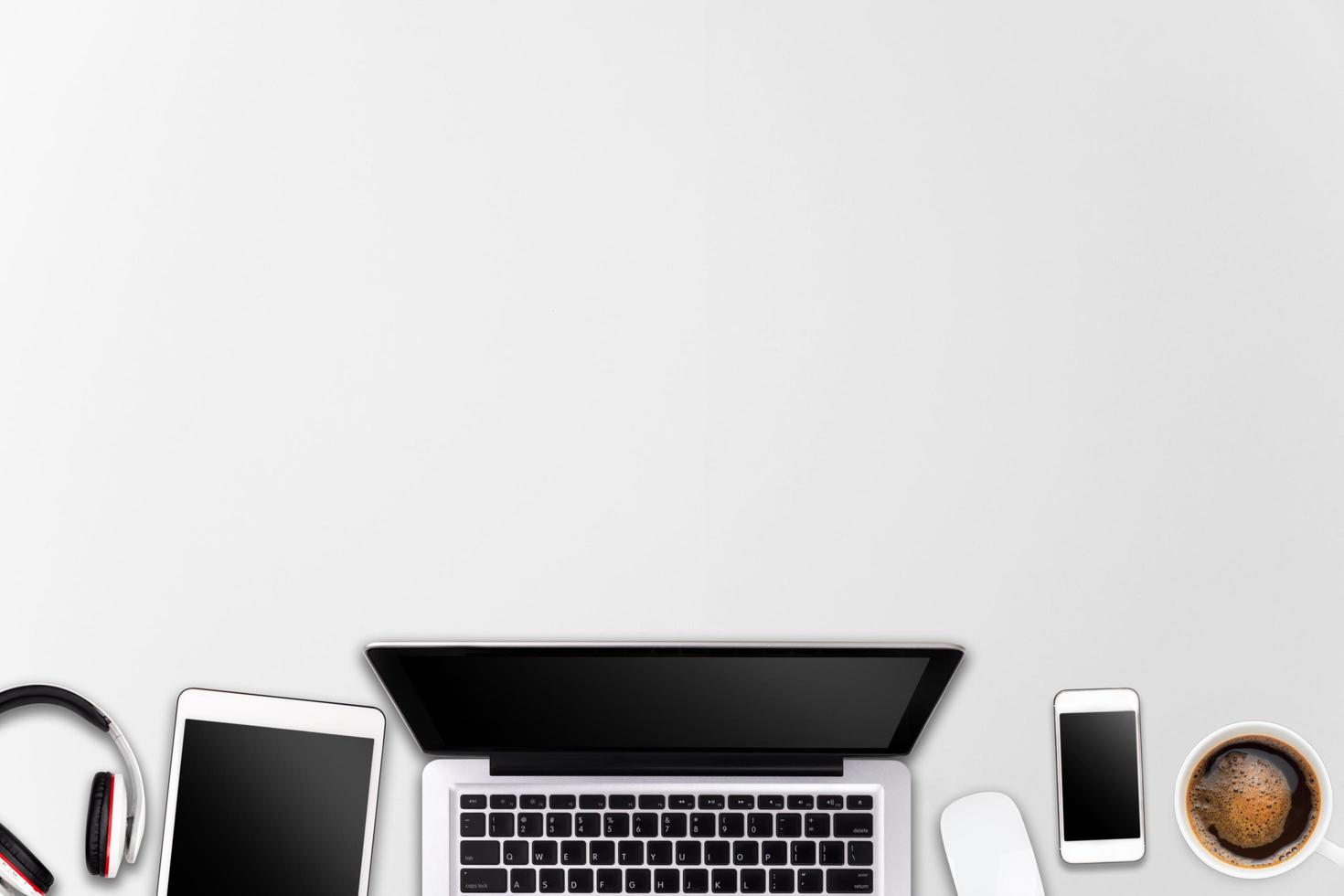 Modern workspace with laptop tablet, smartphone and coffee cup copy space on wood background. Top view. Flat lay style. photo