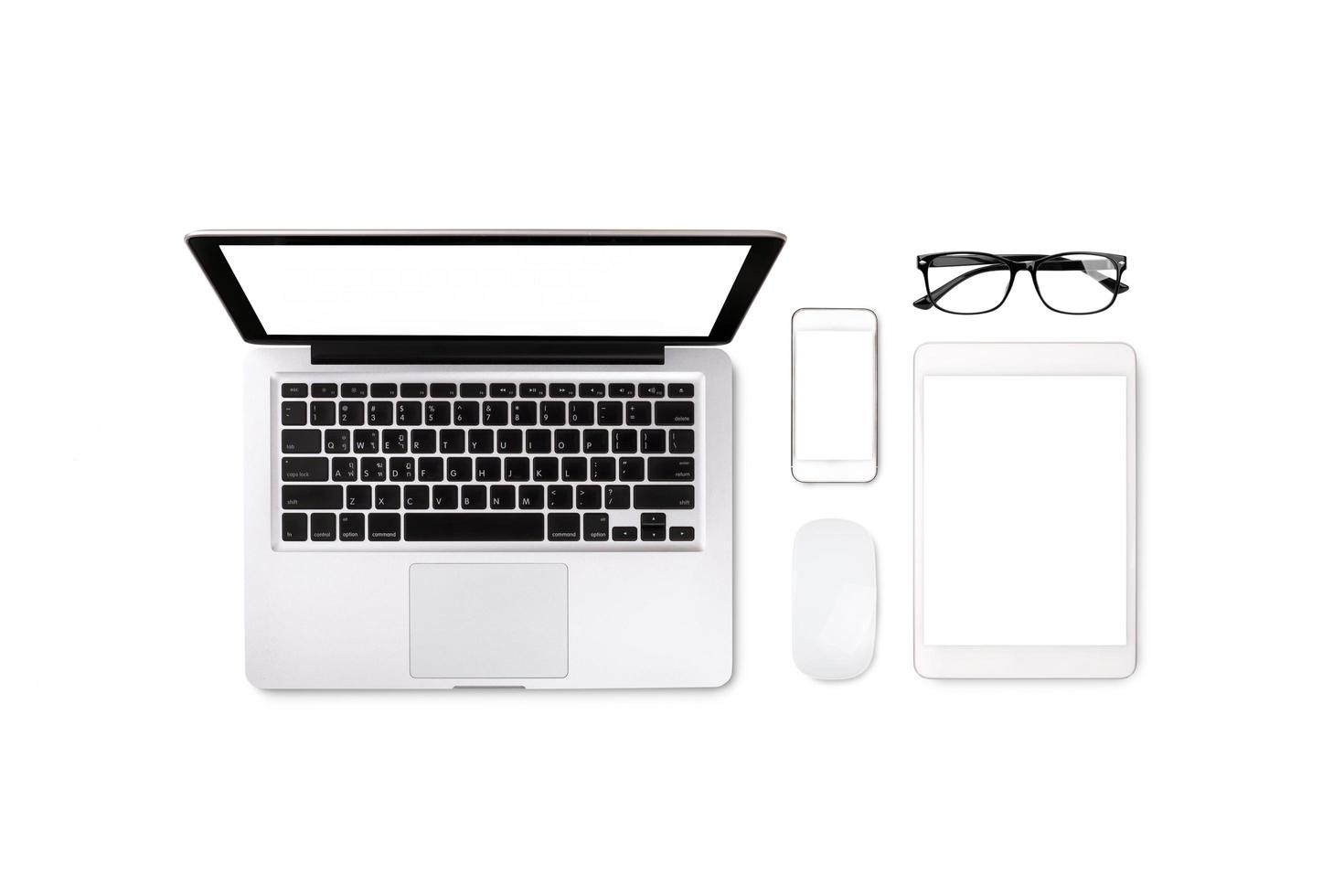 Laptop tablet smartphone and eyeglass on white background with text space and copy space photo