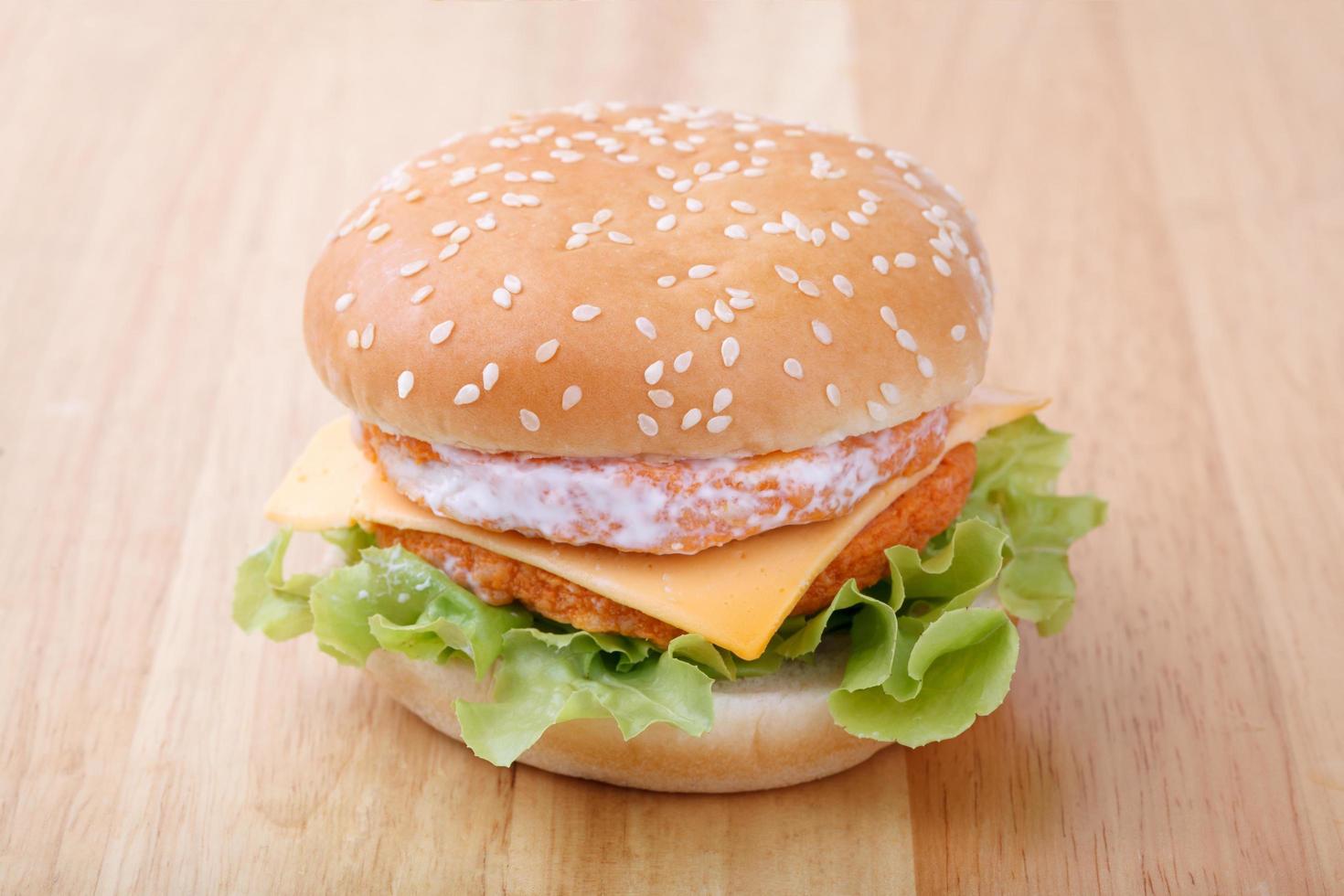 chicken and cheese hamburger on wood background photo