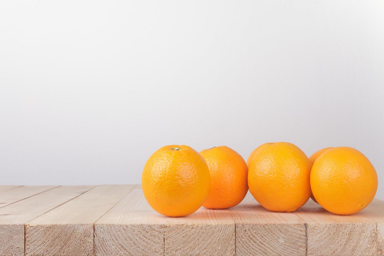 Fresh orange on wood table photo