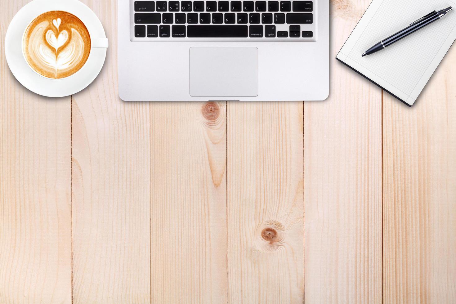 Top view laptop or notebook workspace office and latte coffee on wood table photo