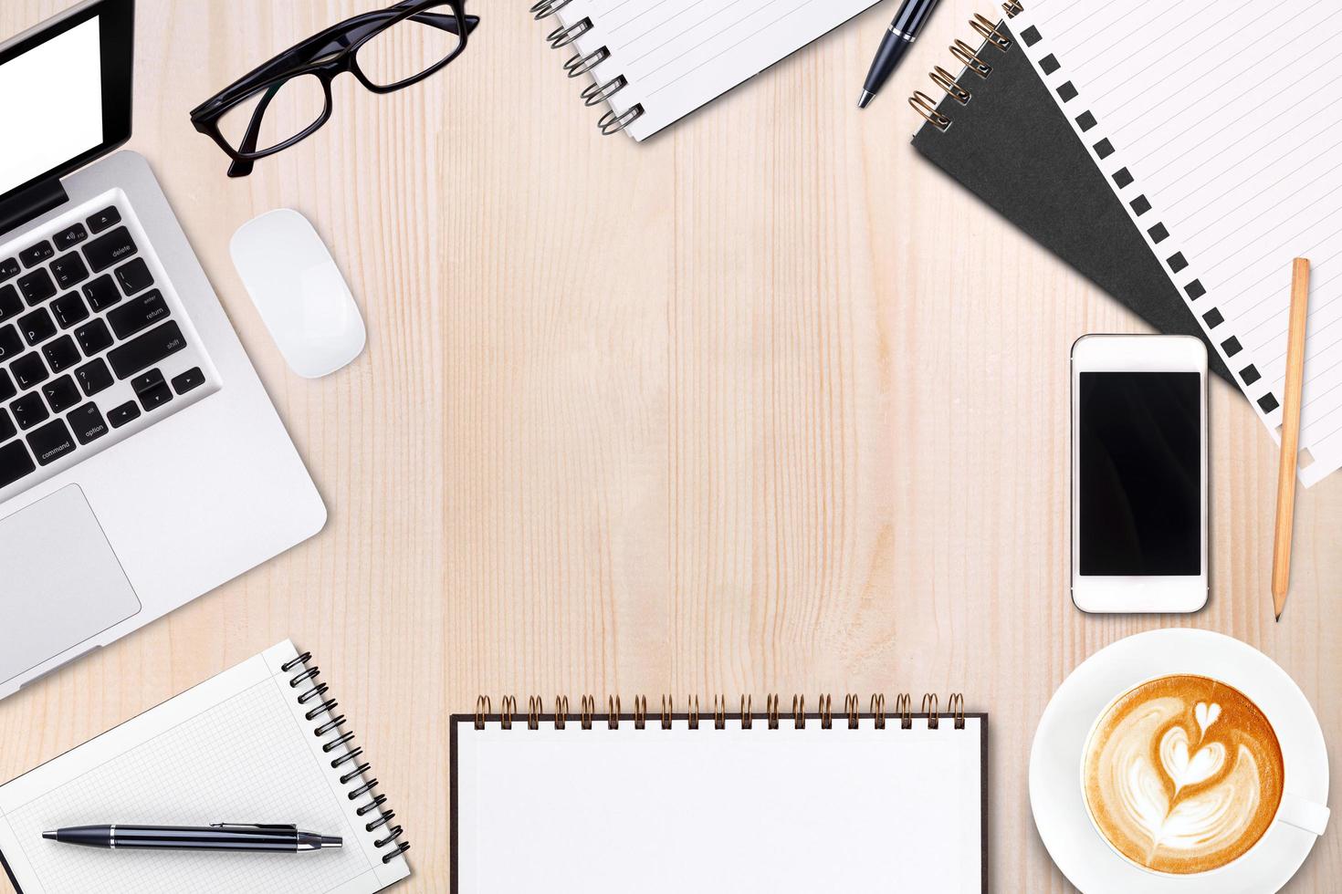 Blank open notebook with pen, glasses and mobile phone,cup of latte art coffee on wooden table.Business template mock up for adding your text.Top view. photo