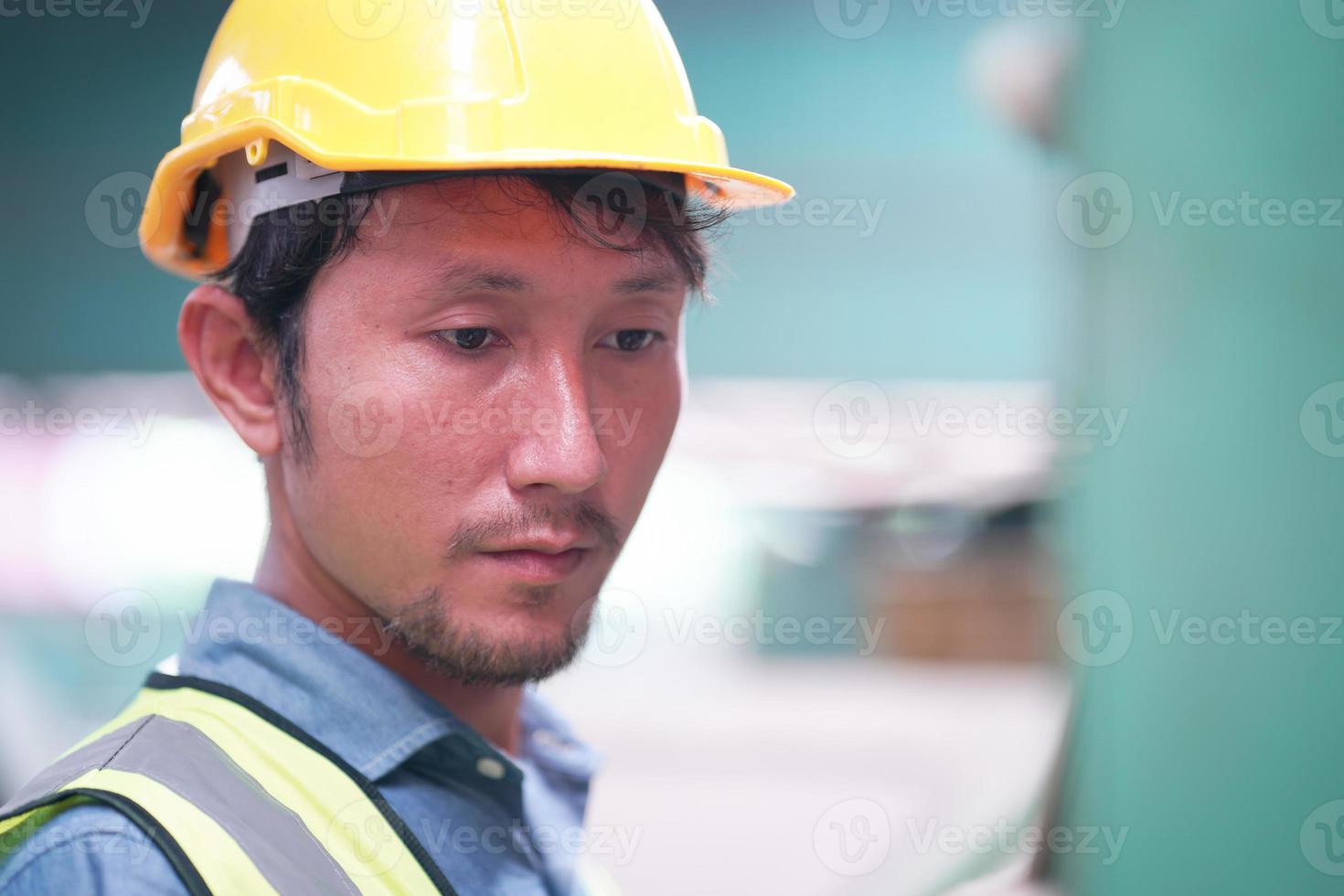 Portrait of a Professional Heavy Industry Engineer Worker Wearing Uniform, Glasses and Hard Hat in a Steel Factory. Industrial Specialist Standing in Metal Construction Facility. photo