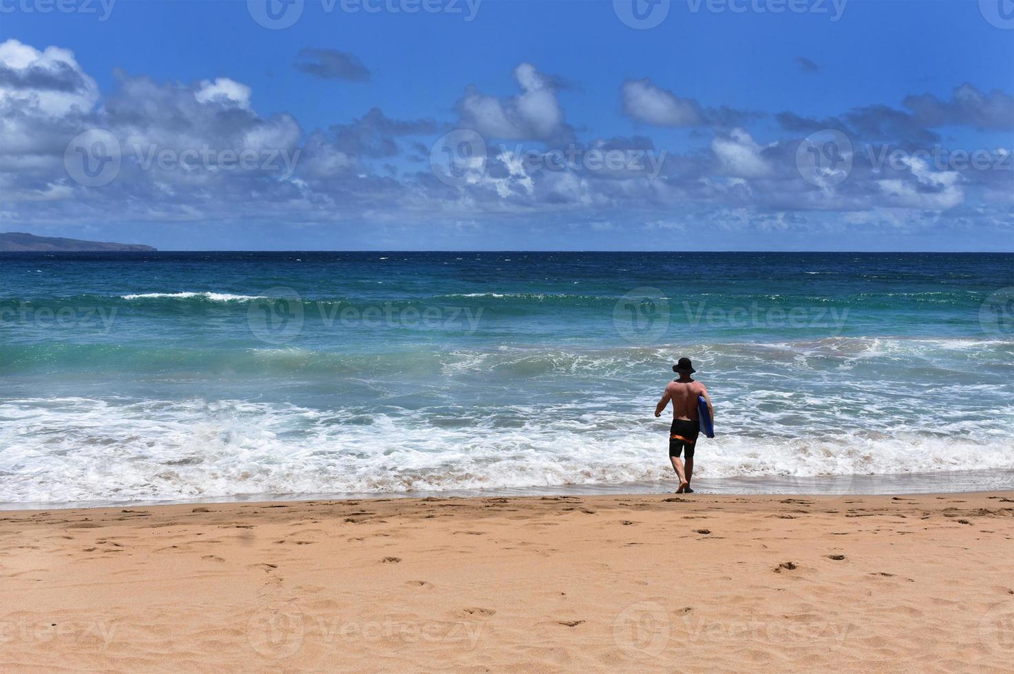 Man at Beach With Surfboard photo