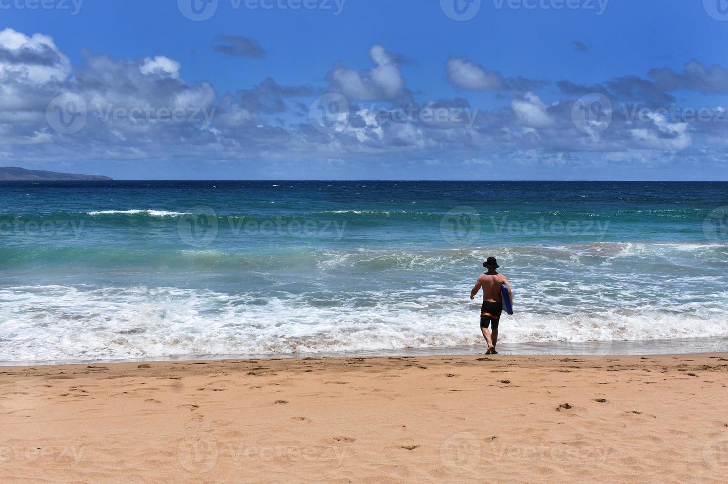 Man at Beach With Surfboard photo