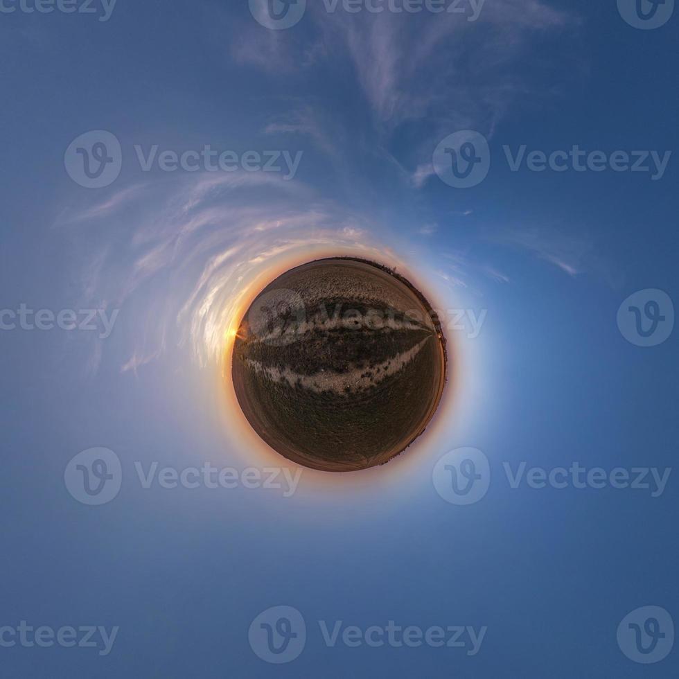 Little planet transformation of spherical panorama 360 degrees. Spherical abstract aerial view in field with awesome beautiful clouds. Curvature of space. photo