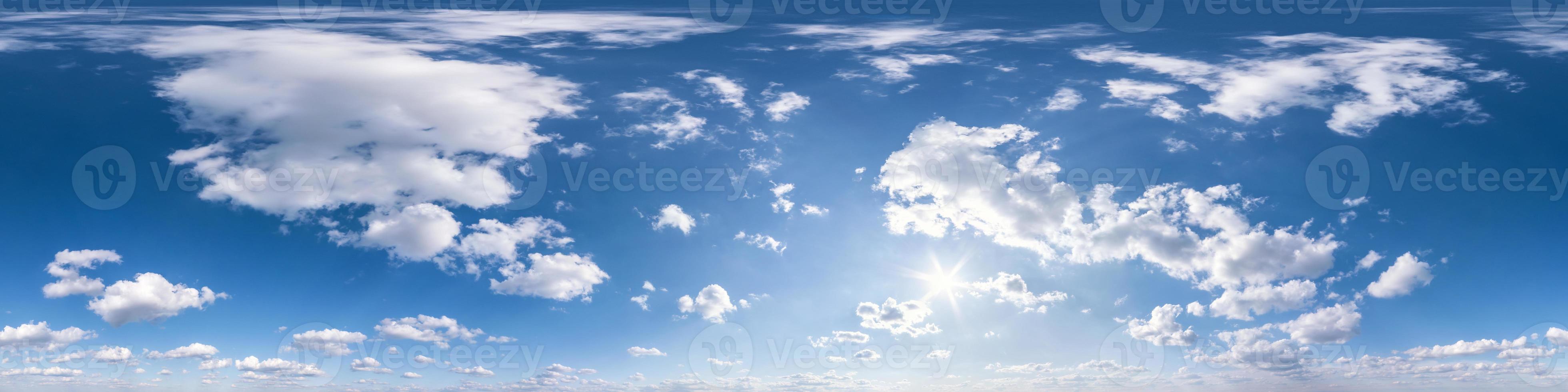 blue sky with sun and beautiful fluffy clouds. Seamless hdri panorama 360 degrees angle view without ground for use in 3d graphics or game development as sky dome or edit drone shot photo