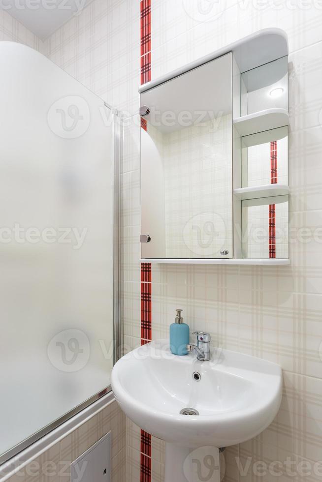 washbasin in bathroom in white style with a red stripe photo