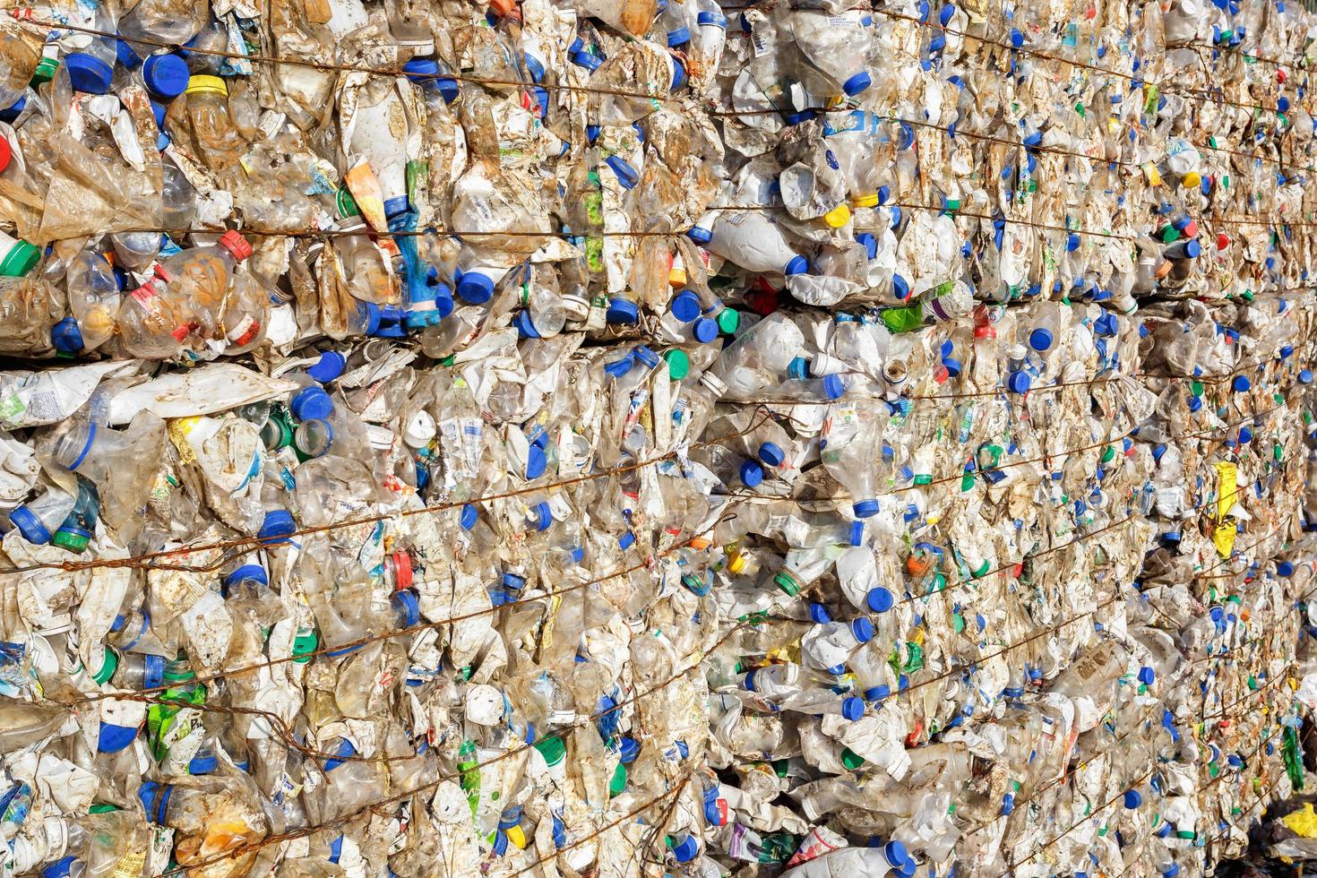 Plastic bales at the waste processing plant. Separate garbage collection. Recycling and storage of waste for further disposal. Business for sorting and processing of waste. photo