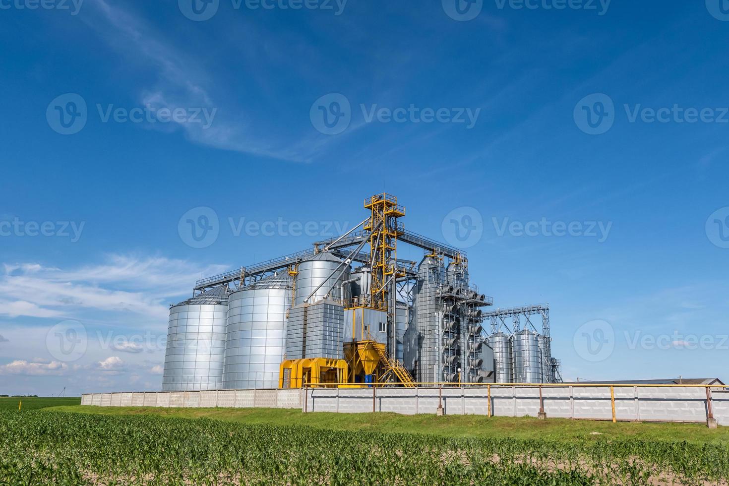 silver silos on agro-processing and manufacturing plant for processing drying cleaning and storage of agricultural products, flour, cereals and grain. Granary elevator. photo