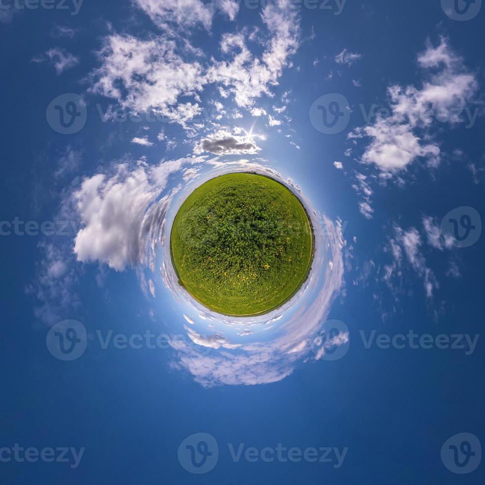 Little planet transformation of spherical panorama 360 degrees. Spherical abstract aerial view in field with awesome beautiful clouds. Curvature of space. photo