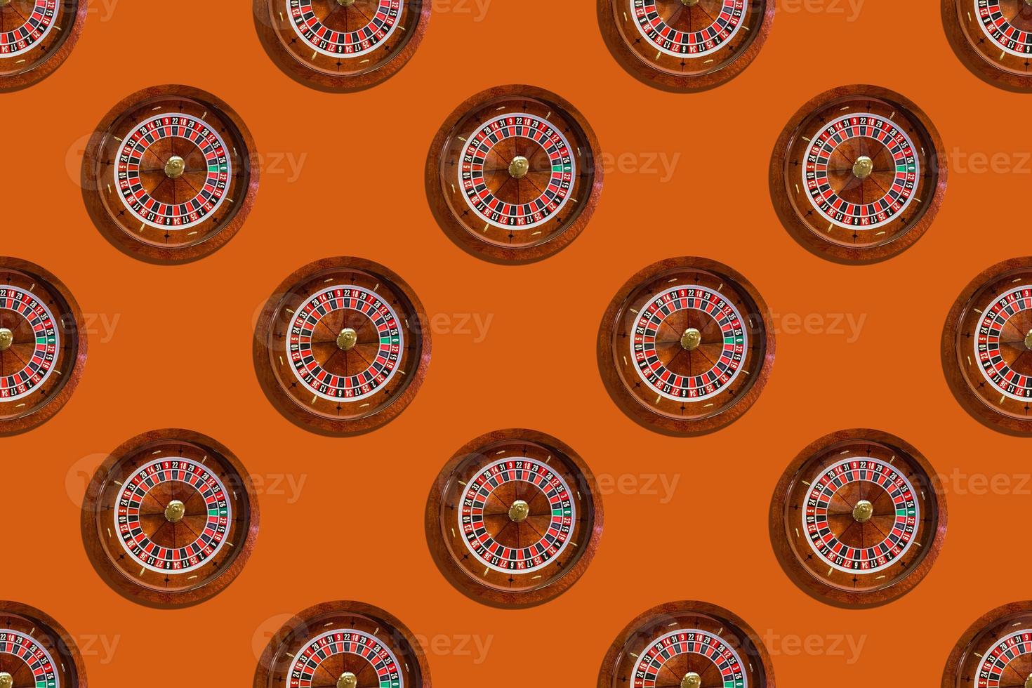 Seamless pattern of game table roulette from elite casino on orange background photo