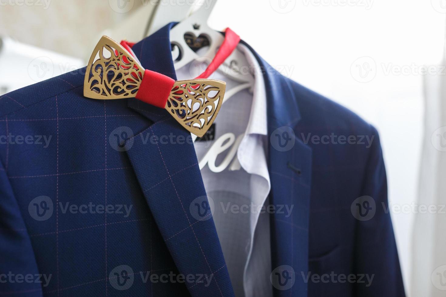 Wooden bow tie on blue jacket photo