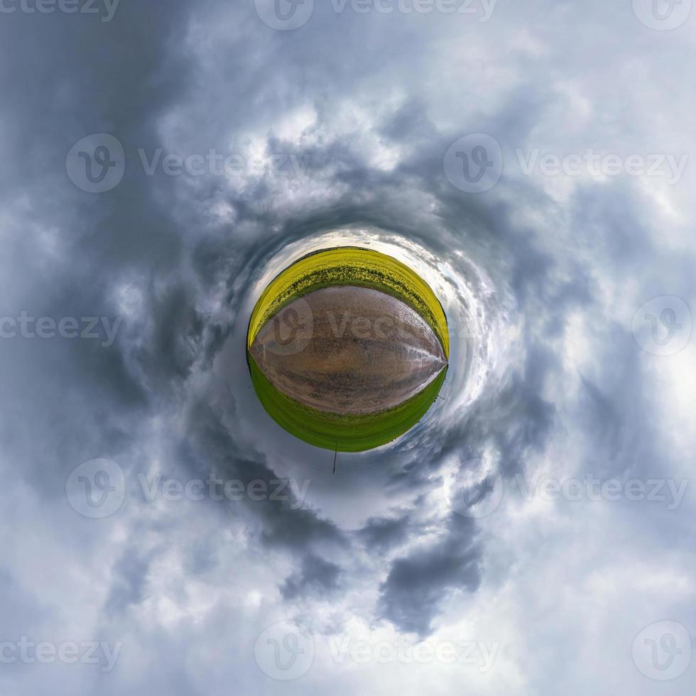 tiny planet in blue sky with sun and beautiful clouds. Transformation of spherical panorama 360 degrees. Spherical abstract aerial view. Curvature of space. photo