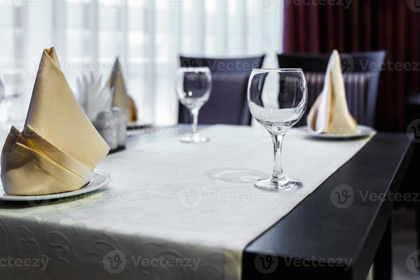 Closeup of empty wine glasses on banquet table in restaurant photo