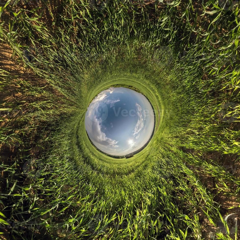 Inversion of little planet transformation of spherical panorama 360 degrees. Spherical abstract aerial view in field with awesome beautiful clouds. Curvature of space. photo