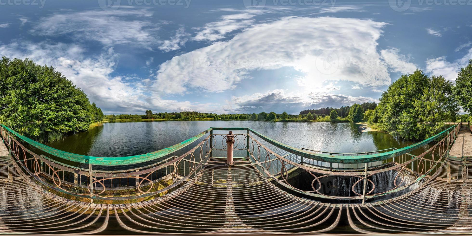 full seamless spherical hdri panorama 360 degrees angle view near the metal dam with waterfall of wide lake in sunny day in equirectangular projection, ready VR AR virtual reality content photo