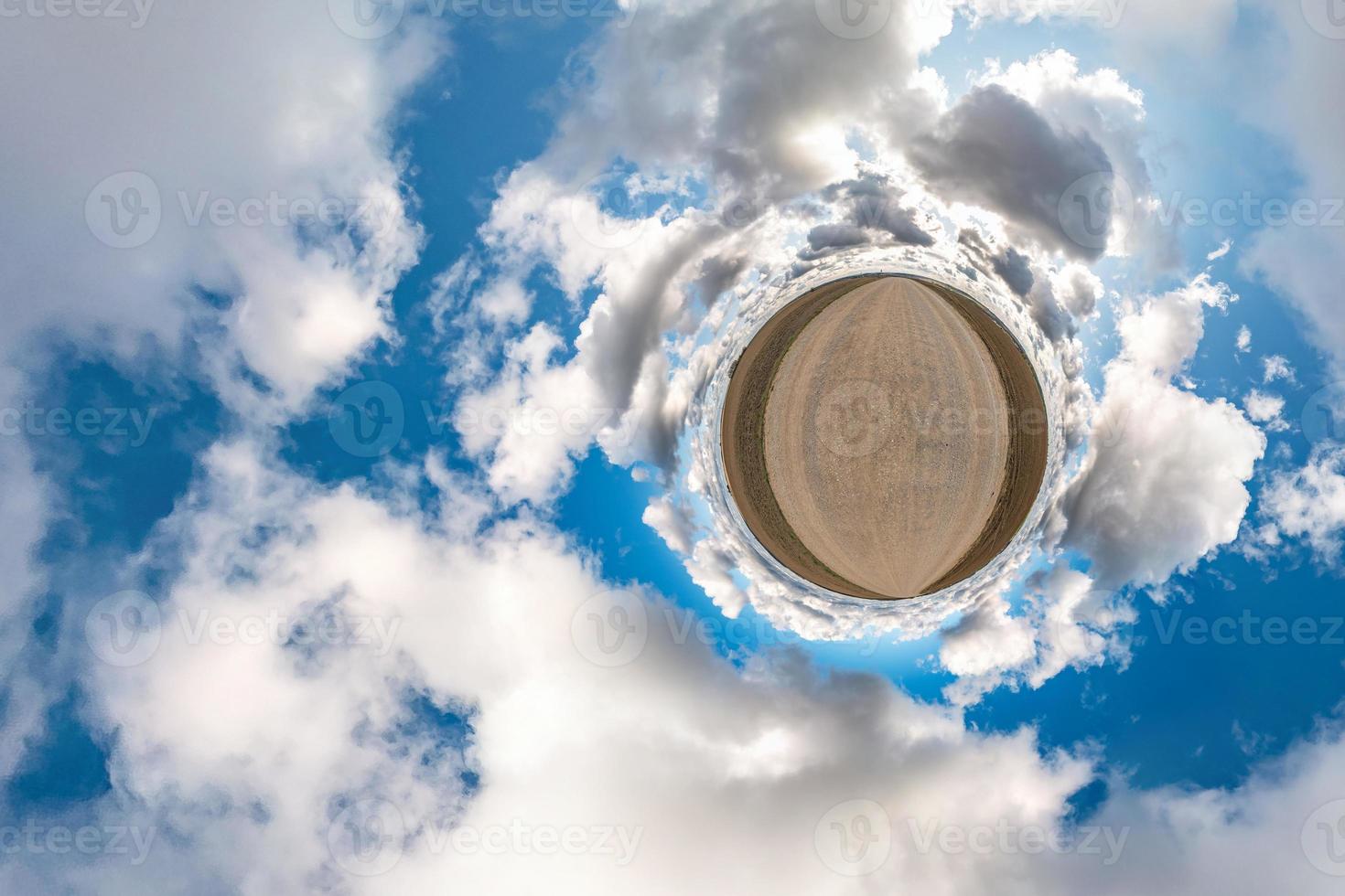 Little planet transformation of spherical panorama 360 degrees. Spherical abstract aerial view in field with awesome beautiful clouds. Curvature of space. photo