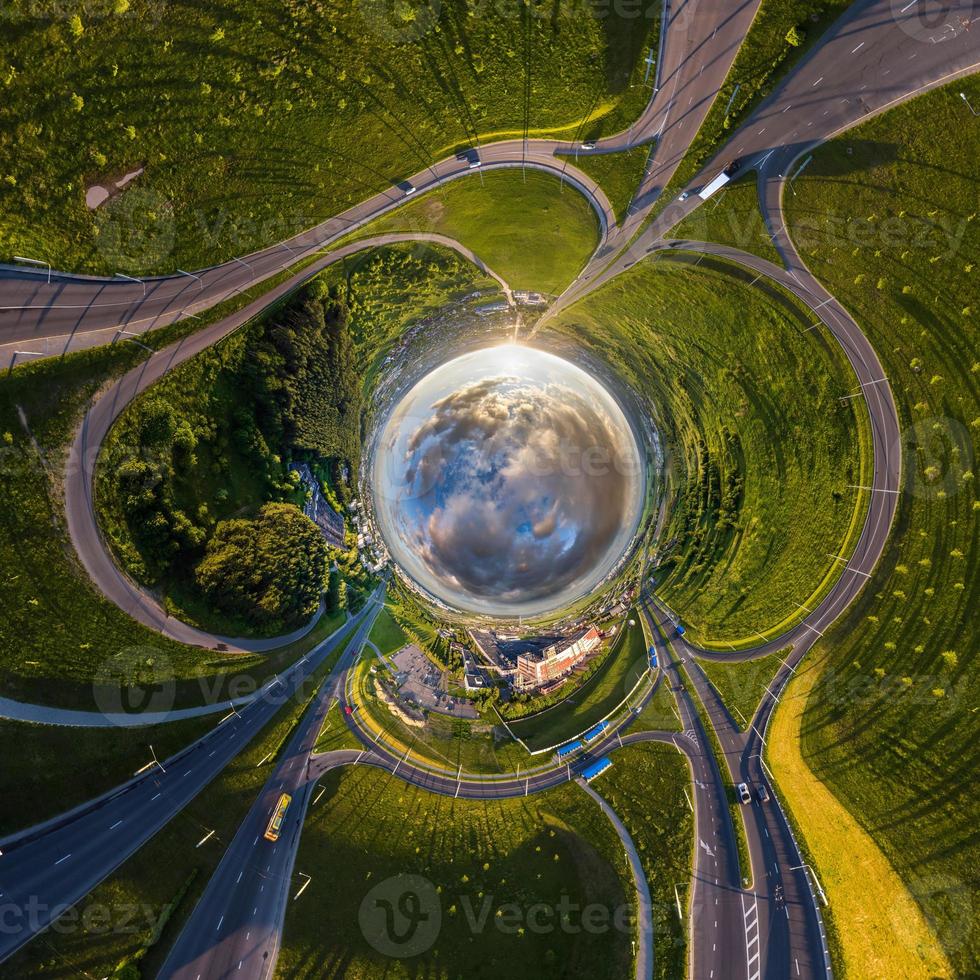 blue sphere of sky with clouds overlooking old town, urban development, historic buildings, crossroads and road junction. Transformation of spherical 360 panorama in abstract aerial view. photo