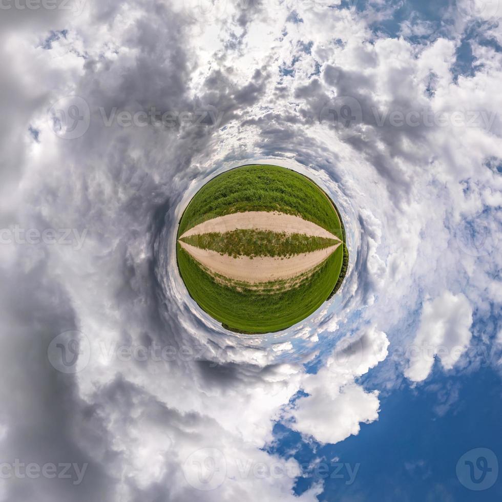 tiny planet in blue sky with sun and beautiful clouds. Transformation of spherical panorama 360 degrees. Spherical abstract aerial view. Curvature of space. photo