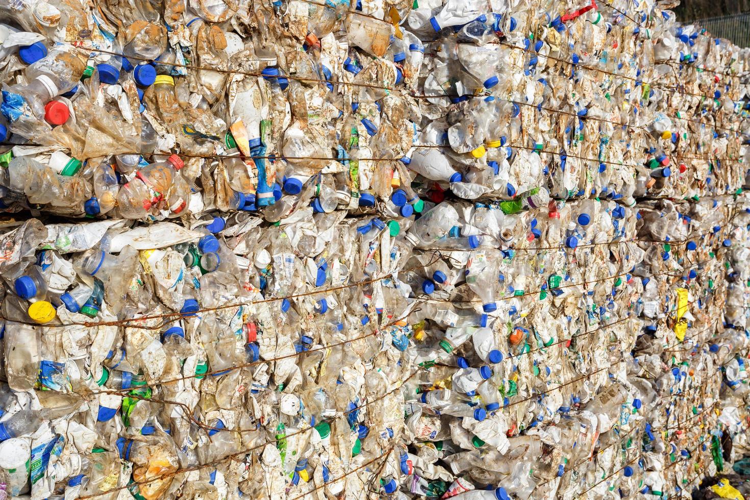 Plastic bales at the waste processing plant. Separate garbage collection. Recycling and storage of waste for further disposal. Business for sorting and processing of waste. photo