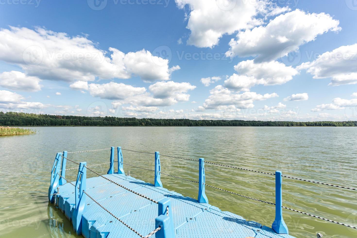 colored plastic pier on the shore of a large lake photo