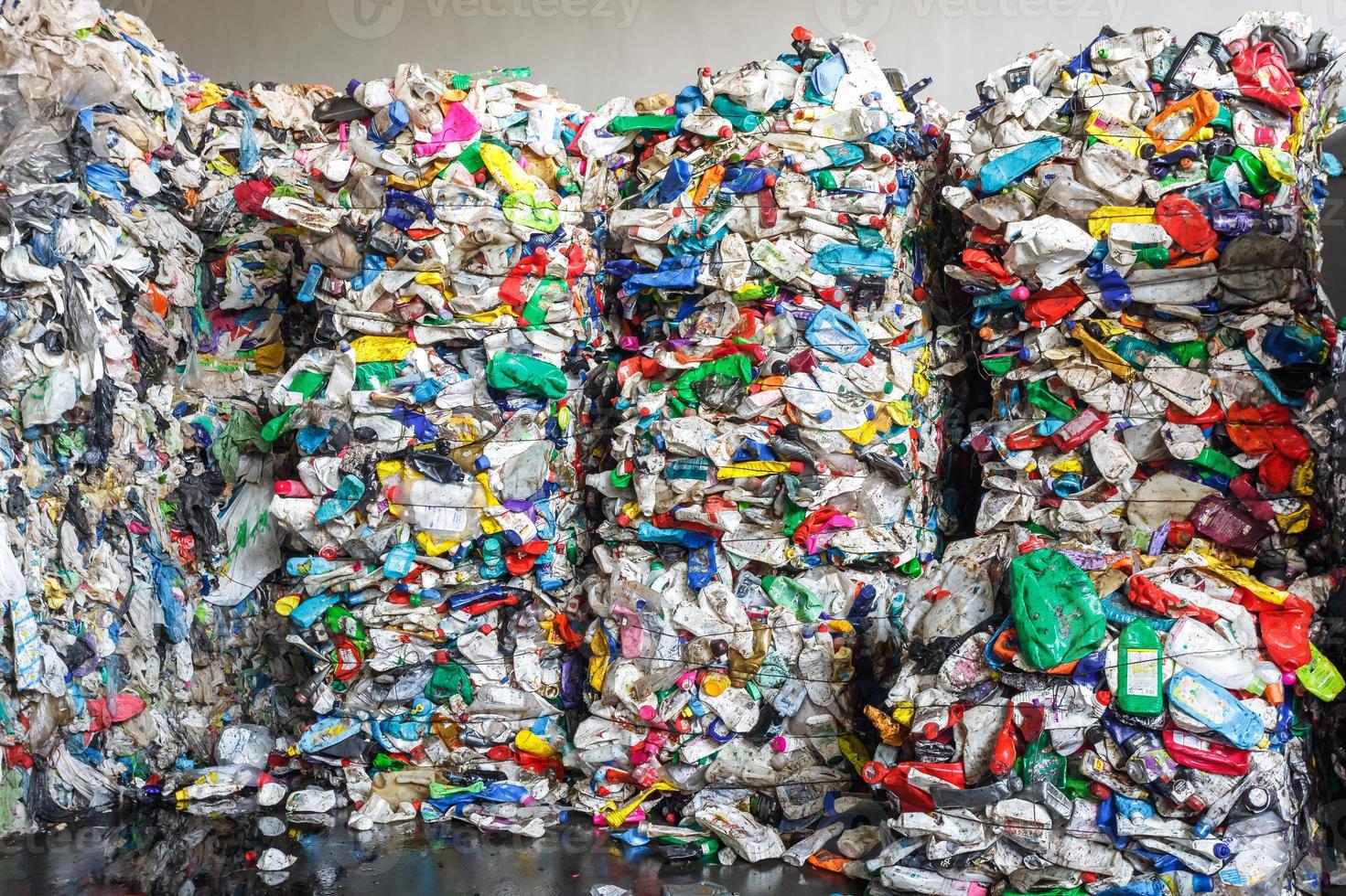 Plastic pressed bales at the modern waste hazardous processing plant. Separate garbage collection. Recycling and storage of waste for further disposal. Business for sorting and processing of waste. photo