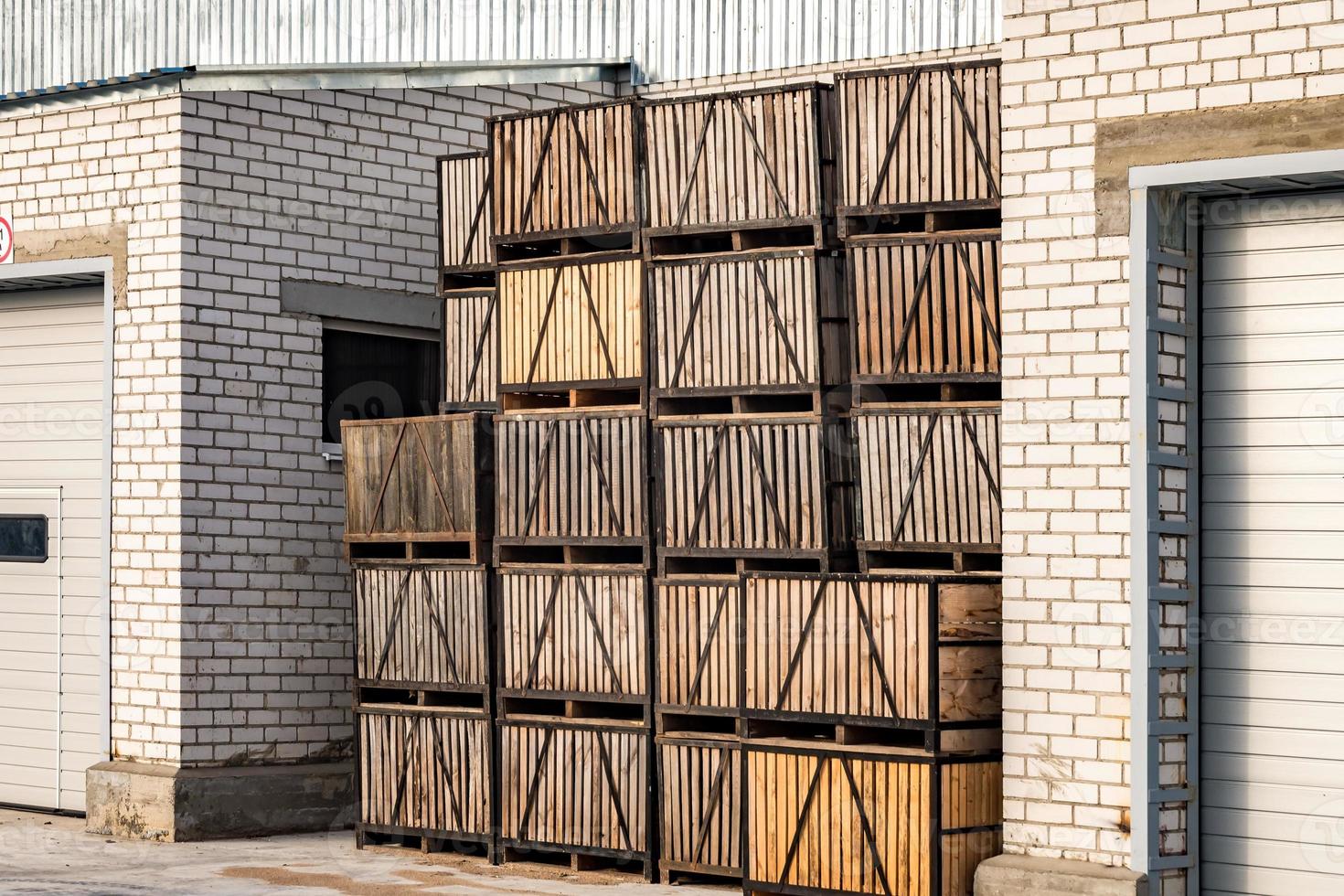 rows of wooden crates boxes and pallets for fruits and vegetables in storage stock. production warehouse. Plant Industry photo