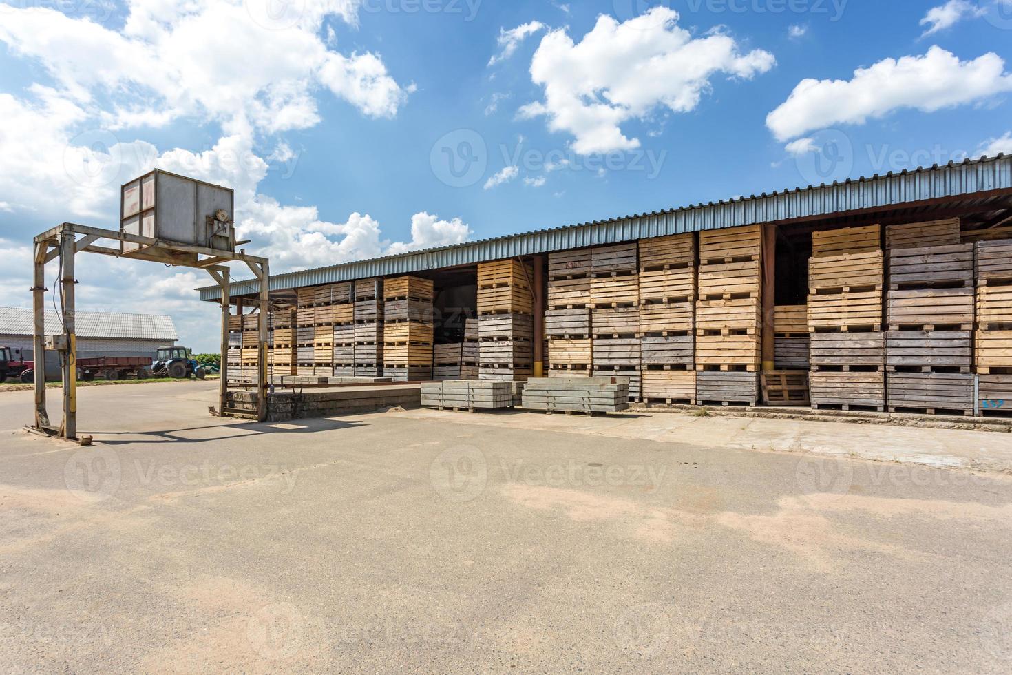 rows of wooden crates boxes and pallets for fruits and vegetables in storage stock. production warehouse. Plant Industry photo