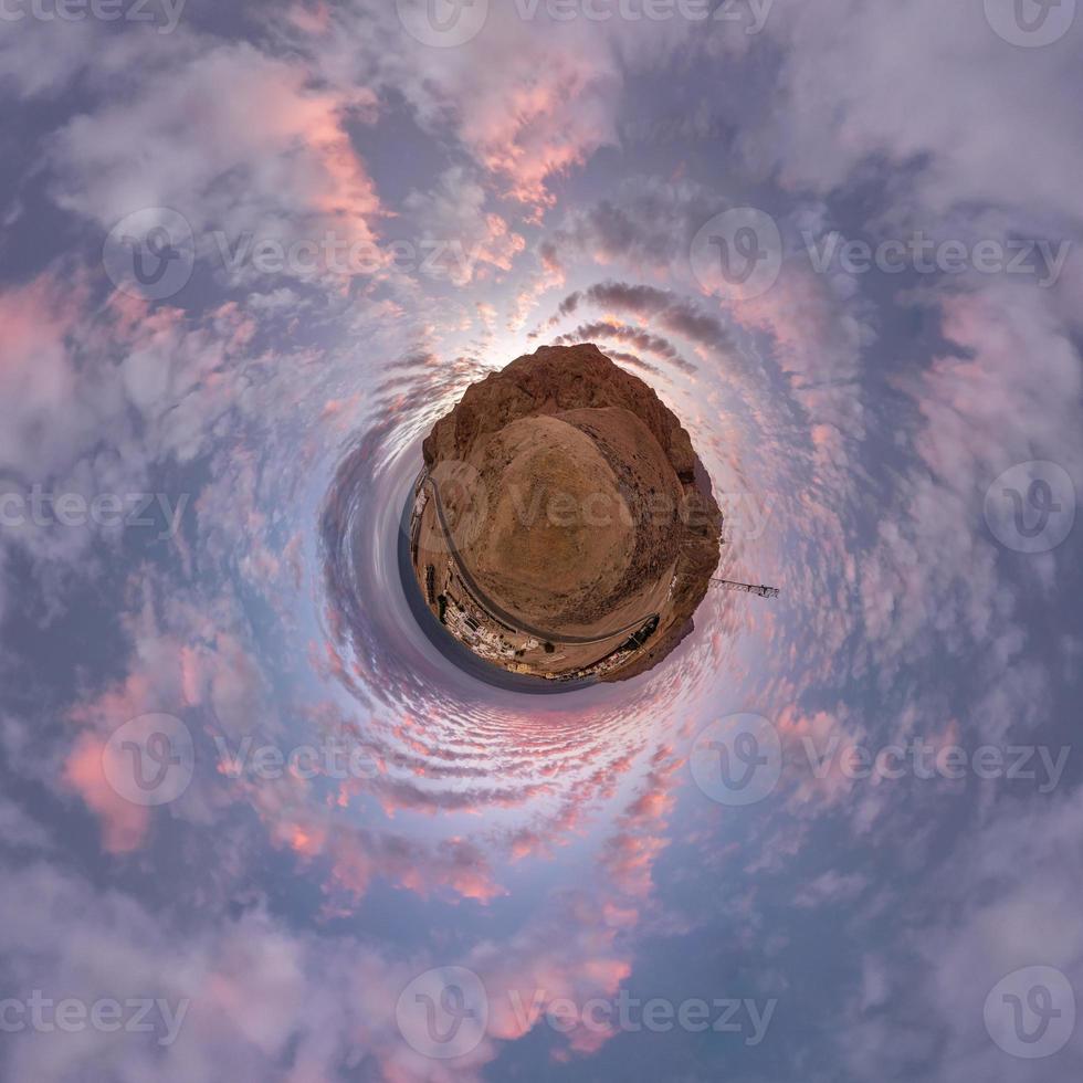 tiny planet in evening sky with beautiful clouds. Transformation of spherical panorama 360 degrees. Spherical abstract aerial view. Curvature of space. photo