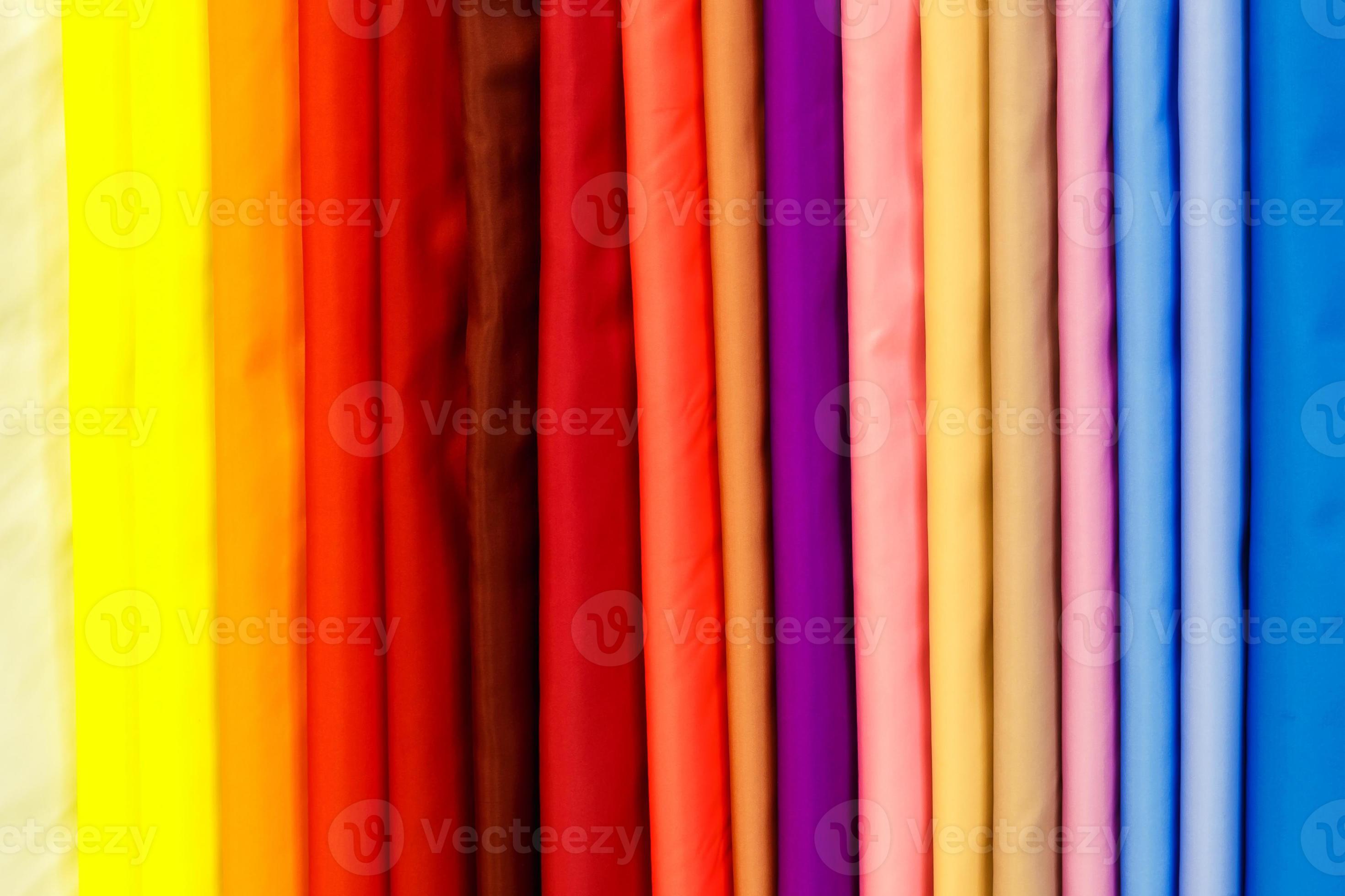 wide selection of different color textile silk fabrics clothes lay in